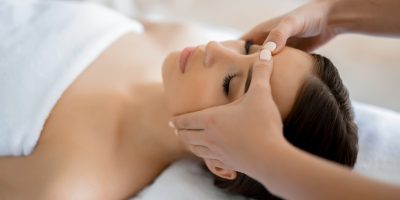 Calm girl having spa facial massage in luxurious beauty salon
