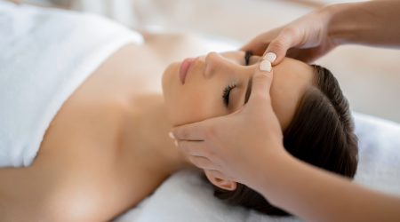 Calm girl having spa facial massage in luxurious beauty salon